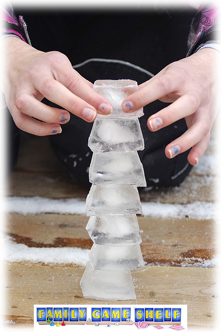 Hands building a stack of ice cubes for Minute to Win it Winter Edition