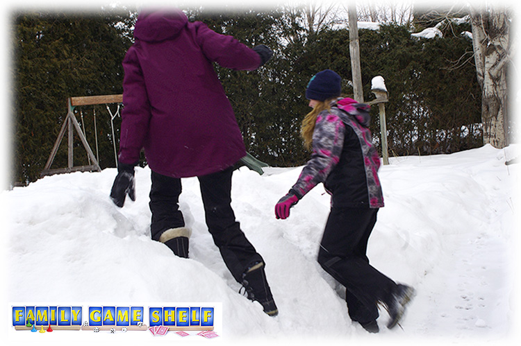 Two players climbing large snow hill for Winter Minute to win it game