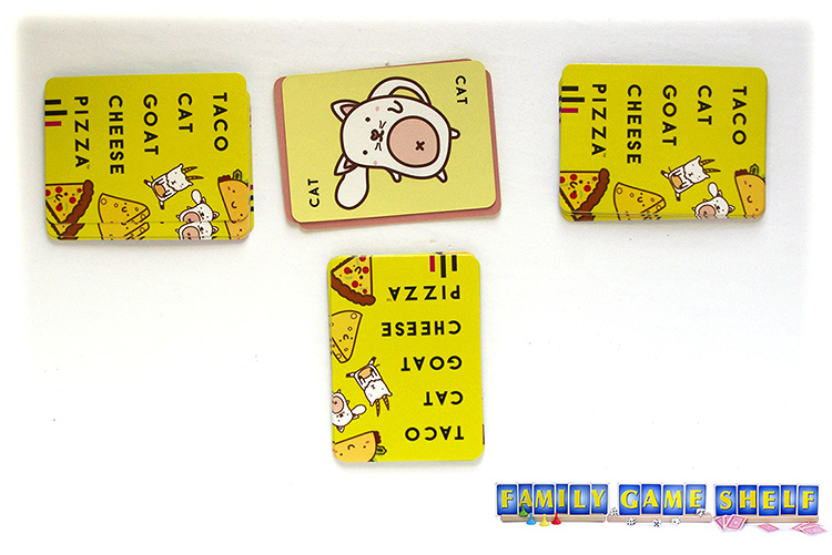 The Taco Cat Goat Cheese Pizza cards in piles with a cat flipped up
