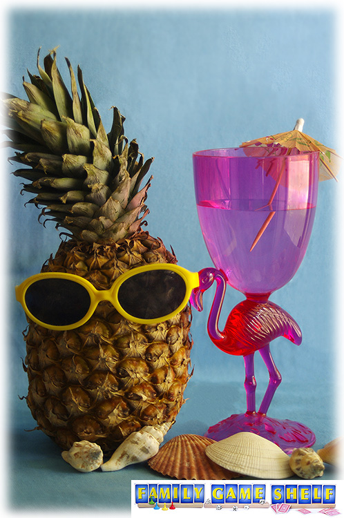 A pineapple wearing sunglasses with other luau decorations