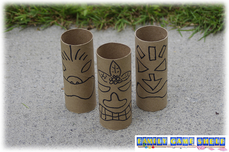 Toilet paper tubes with Tiki faces on them set up as bowling pins in this Luau  Party Game