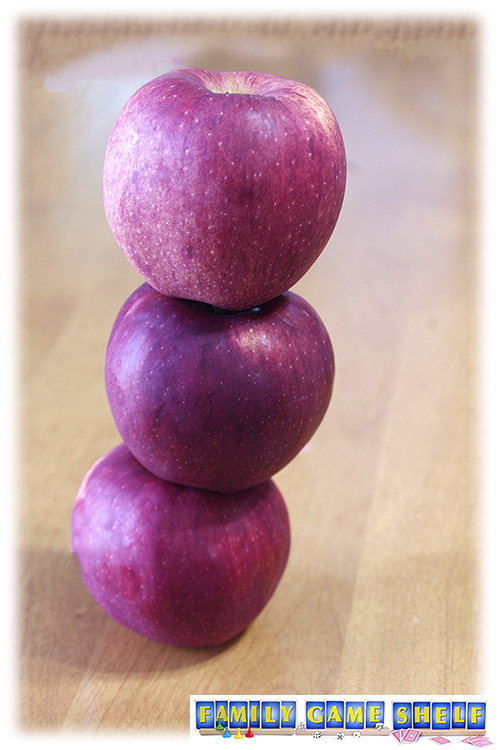 A stack of three red apples for minute to win it back to school game