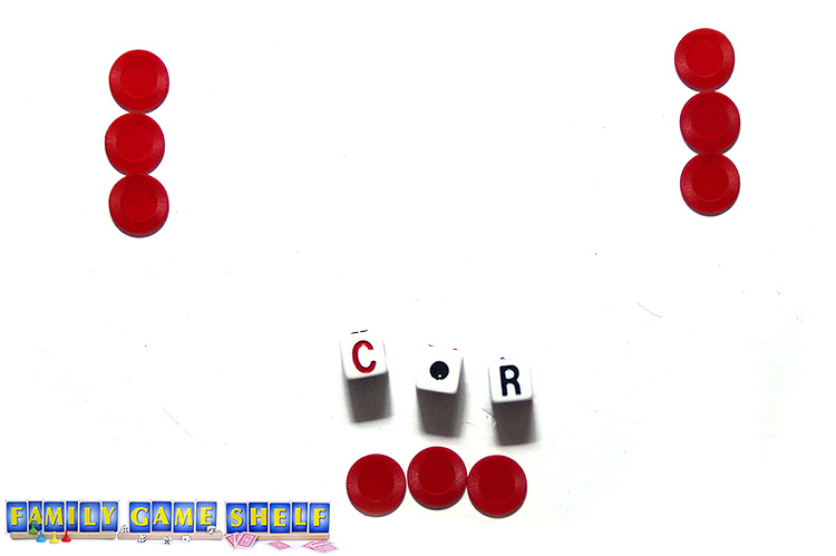 Three sets of LCR chips and dice showing a C, R and a dot