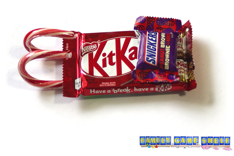 Grinch Party craft of candy canes under a KitKat bar making a sled