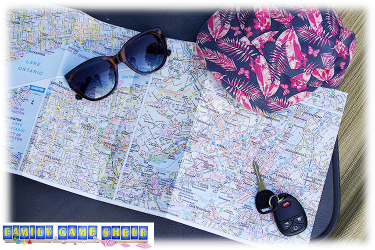 Closeup of map with sunglass, hat and keys for summer road trip games
