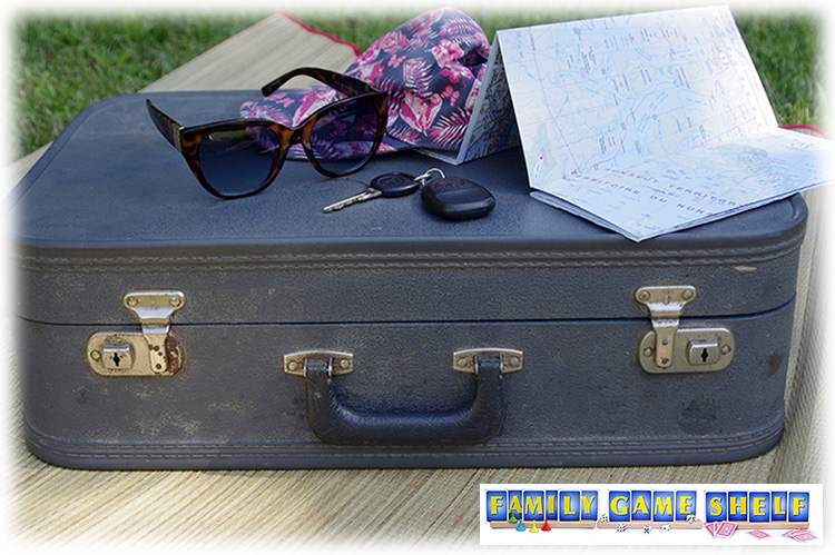 old suitcase with keys, map, hat for summer road trip games