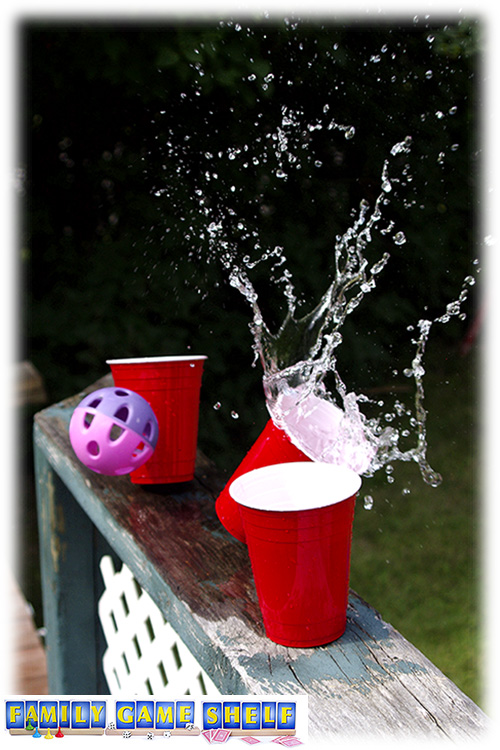 A ball hitting a cup full of water 
