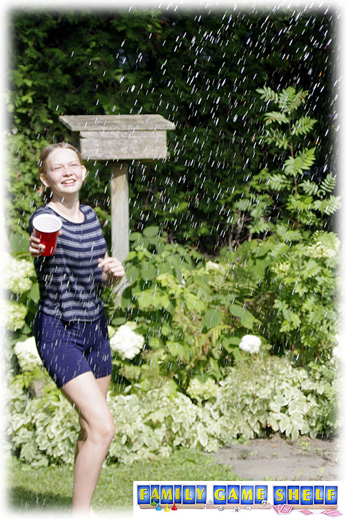 Minute to win it player catching raindrops with a cup