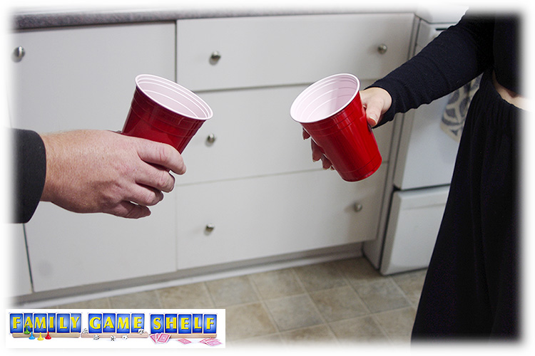 Two Pumpkin Seed Games players holding cups