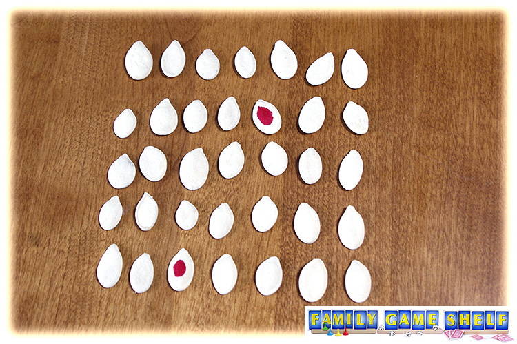 Pumpkin seeds in a grid showing two matching colours.
