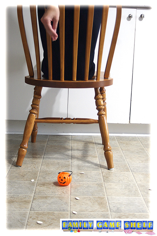 Player on chair dropping seeds into pumpkin