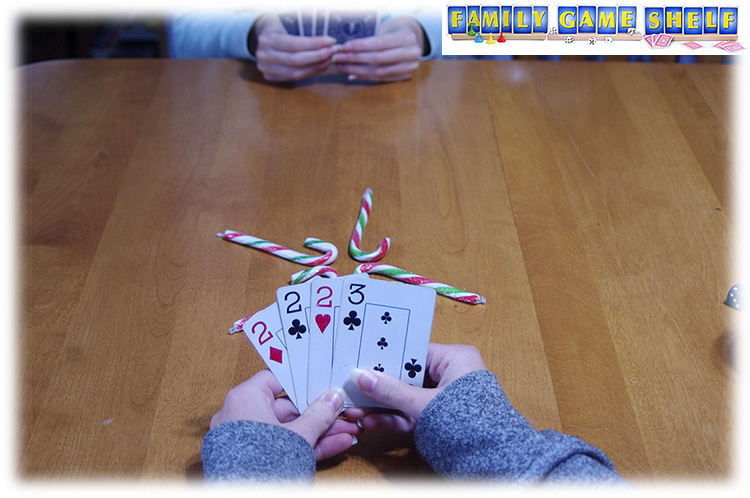 Candy Cane Card game player with three2s and one 3