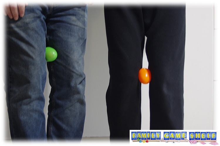 Thanksgiving games players with plastic eggs in between their knees