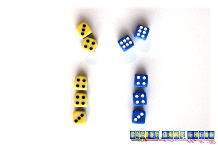 two sets of dice playing the Winter Carnival dice game Egg Toss with three matching dice and two left