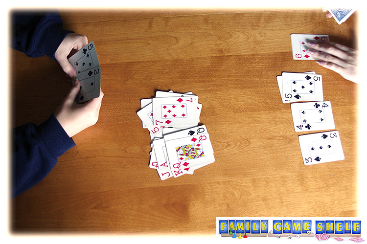 One player has only two cards left and can pick them up in her hand.