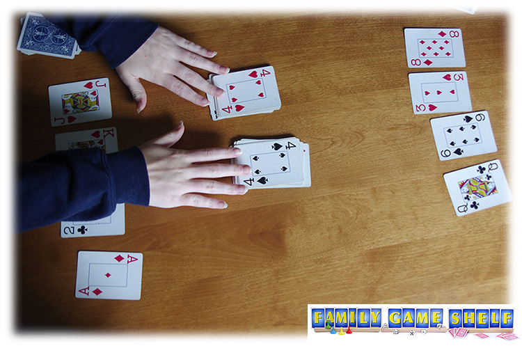 A stress card player covering the center stacks with her hands.