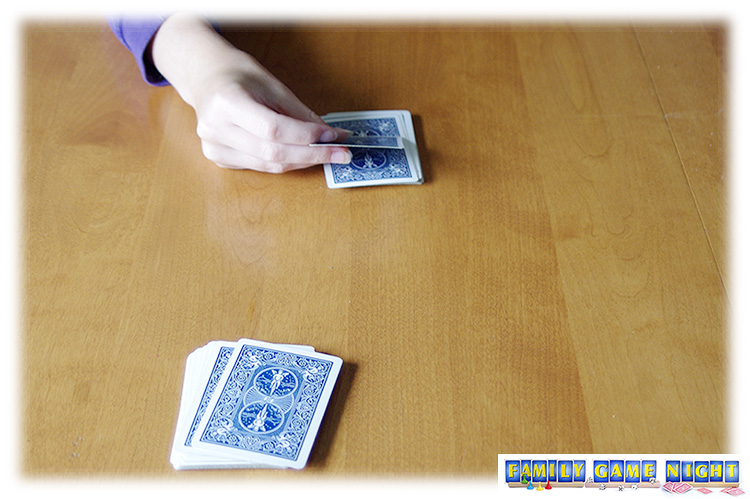 A Snap card game player flipping the card away from her.