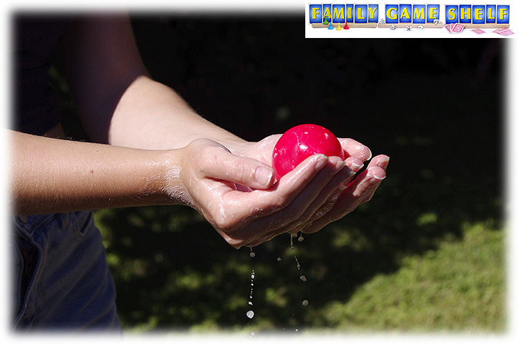 Soapy hand holding a water balloon