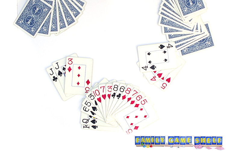 An Ugly card game player with a full hand and passing the jack of clubs, jack of spades and 3 of diamonds and getting the four of hearts an spade and the 5 of hearts.