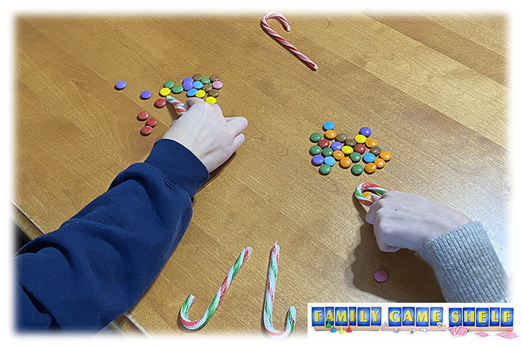 Players sorting candy with a candy cane