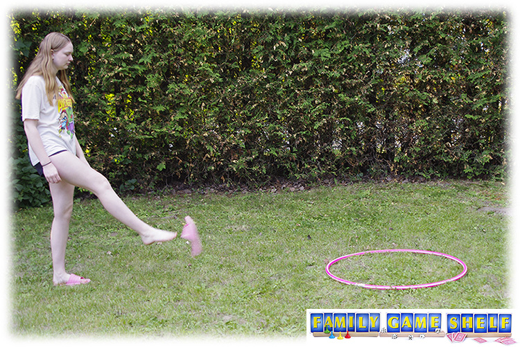 Don't Be last summer game flip flop fling where a girl is using her foot to fling a sandal into a hula hoop