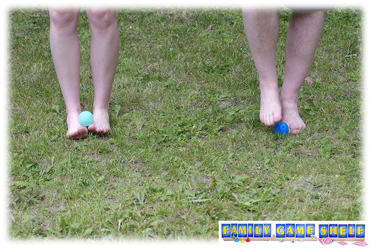 Don't be Last Summer game Penguin march with two people having water balloons on their feet.
