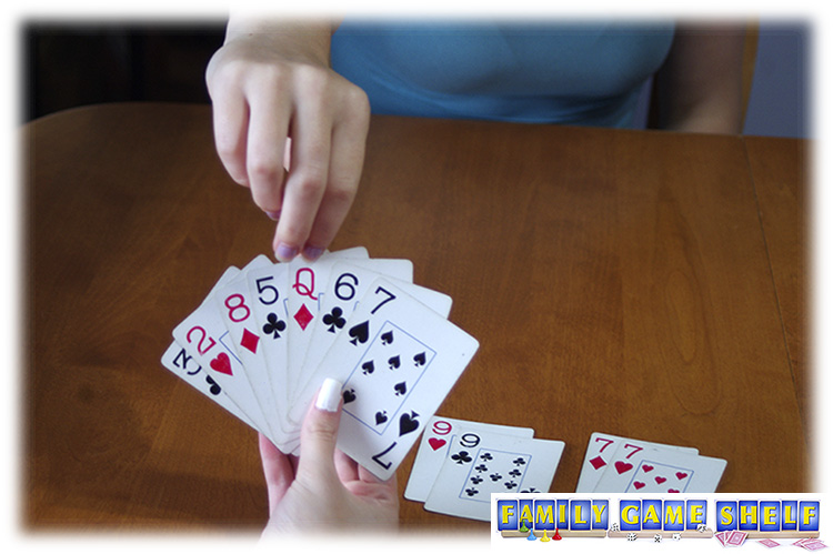 A player picking a card from the other hand.