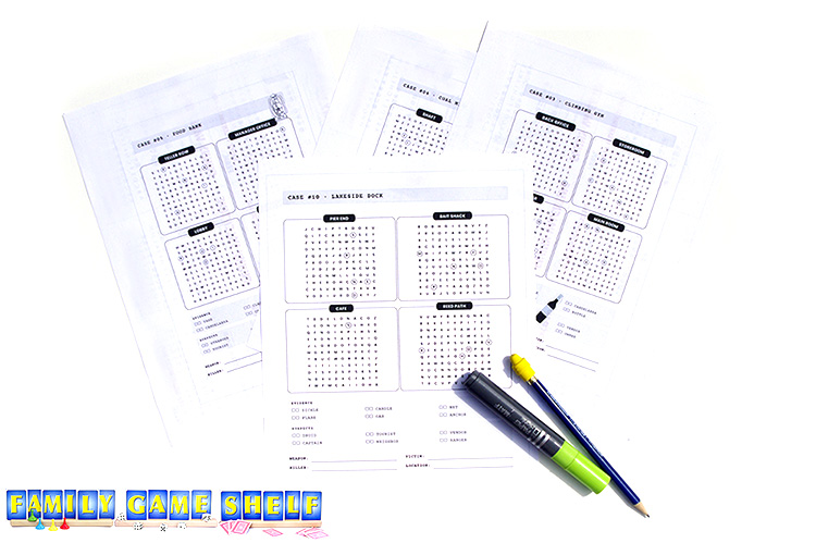 Several murder mystery word searches printed out with a pencil and highlighter