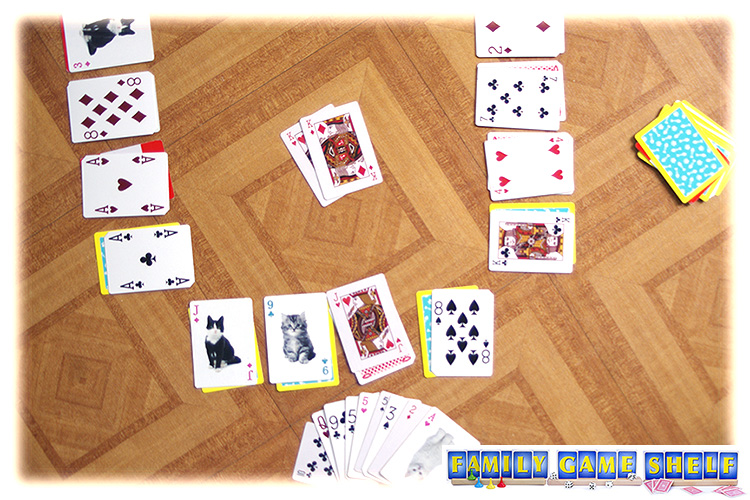 A swoop card game player placing two king in the middle